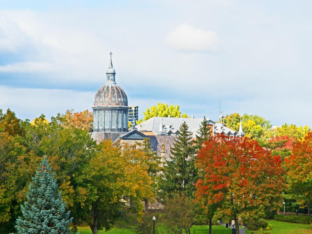 Trois Rivieres, Quebec, Canada with the dome of the Ursuline Convent surrounded by trees marked with their fall colors taken on a sunny day.