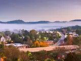 Asheville, North Carolina, downtown skyline at dusk with mountains and fog in the background