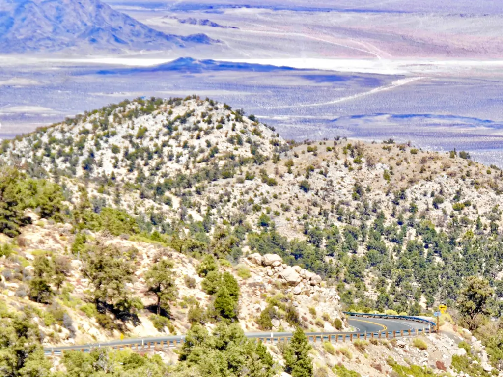 View of the valley from a vantage point with a twisty highway in sight among the hills