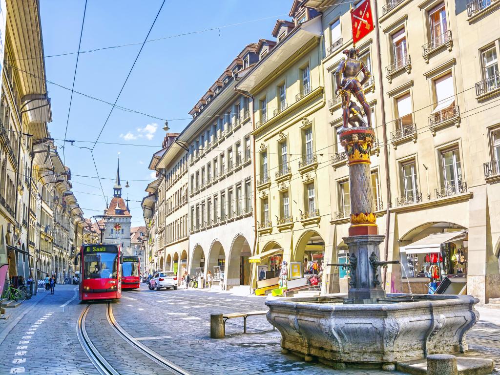 Streets with shopping area and fountain in the historic old medieval city centre of Bern, Switzerland.