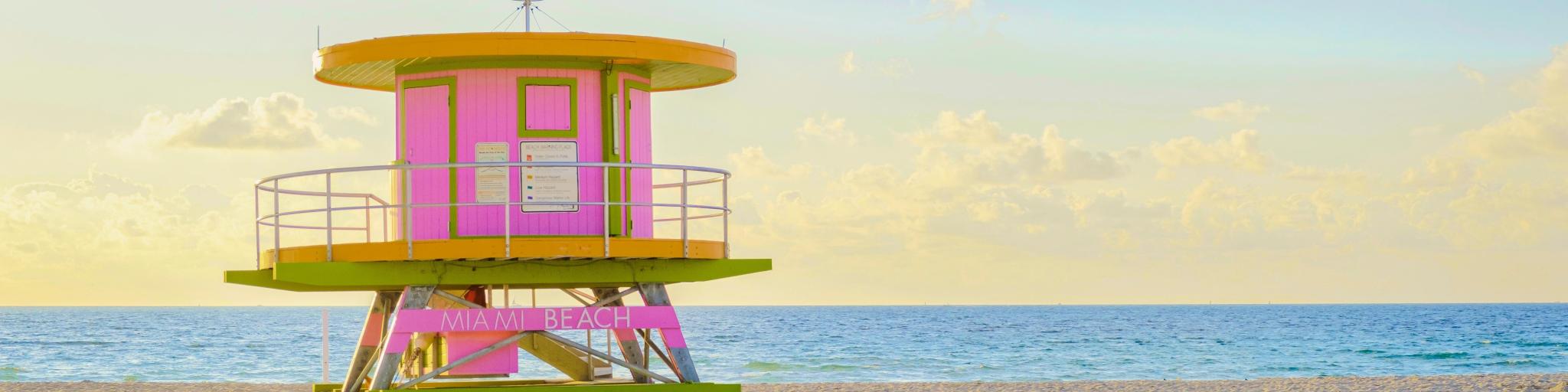 Pink lifeguard hut on Miami Beach with the ocean in the background