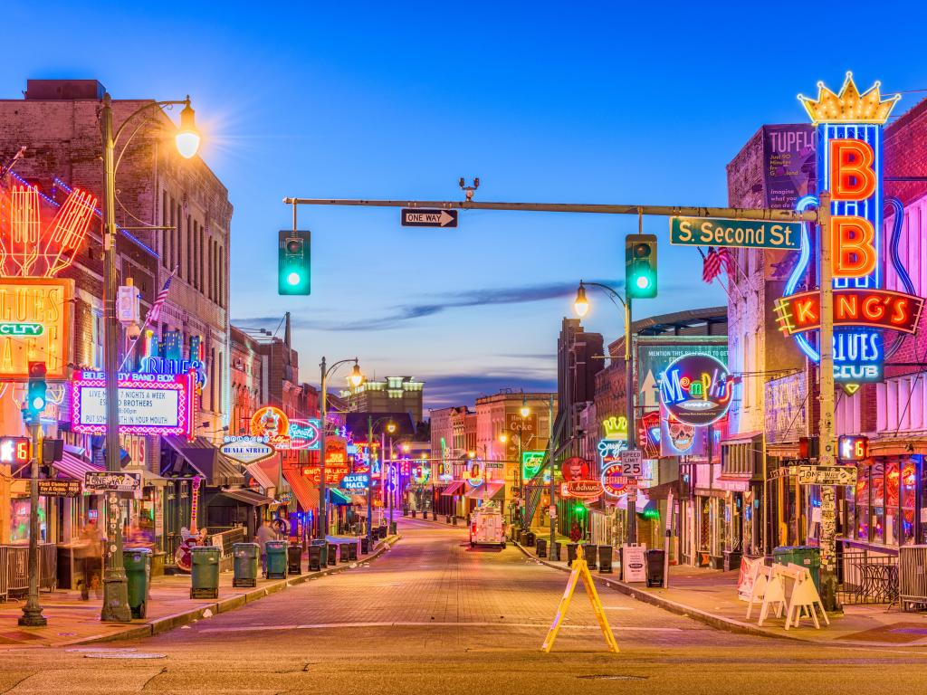 Beale Street in Memphis, TN at twilight with bright neon lights illuminated