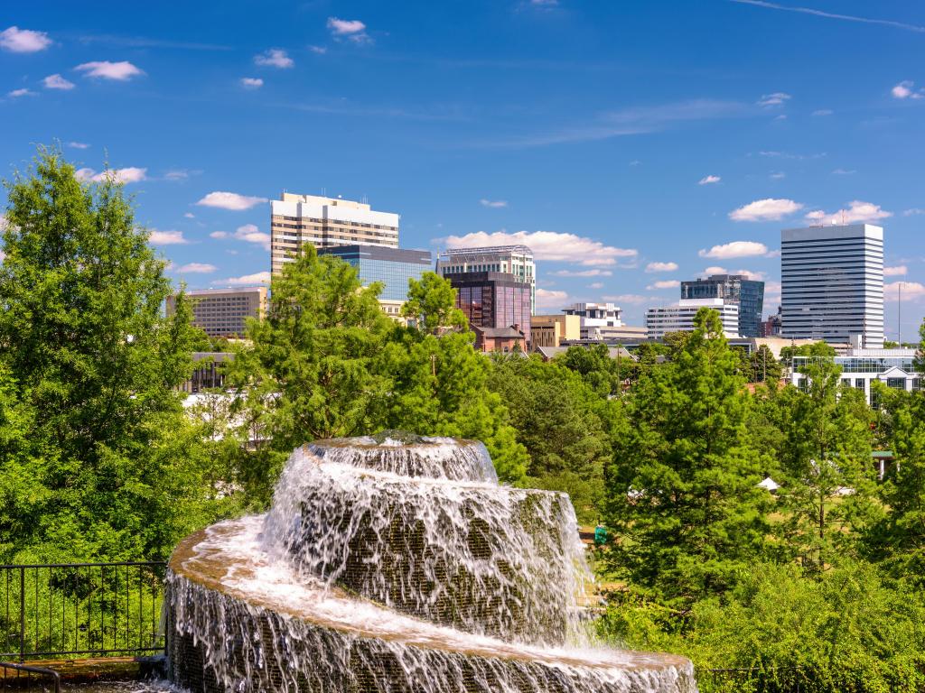 Columbia, South Carolina, USA at Finlay Park Fountain taken on a sunny day with the city skyline in the distance. 