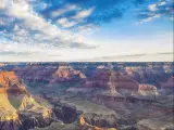 A breathtaking view of the Grand Canyon illuminated by the morning light with a cloudy sky