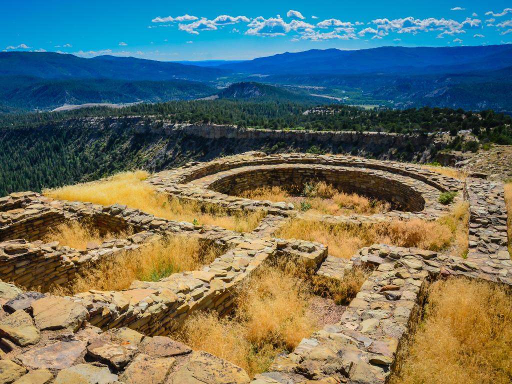 Ancient Ruins at Great Kiva, part of the Chimney Rock National Monument, with the expansive Chaco Canyon visible in the distance