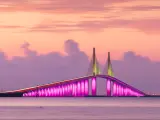 Sunshine Skyway Bridge, St. Petersburg spanning the Lower Tampa Bay at sunset and lit up in a bright pink.
