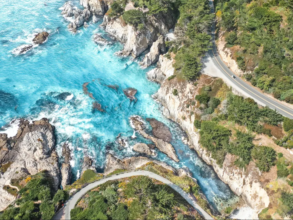Aerial shot of the Pacific Coast Highway running along the rugged shoreline