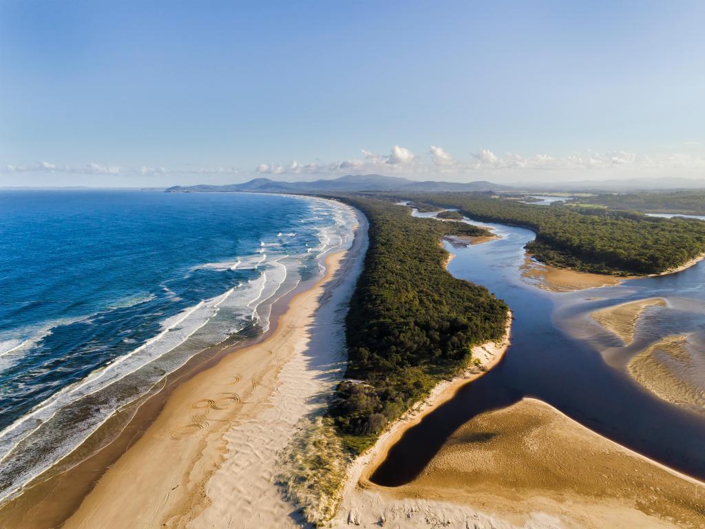 Gaagal Wanggaan National Park, NSW, Australia taken at south beach in National park near Nambucca heads regional NSW town and Warrell creek waters meeting at the river mouth to pacific ocean.