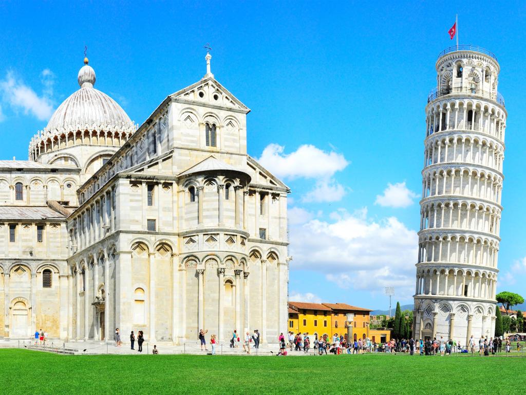 Tourist visiting the leaning tower of Pisa, Italy on a sunny day