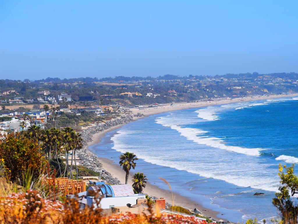 Birds eye view of Malibu Beach, from the ocean, to the white sands and Malibu build up itself