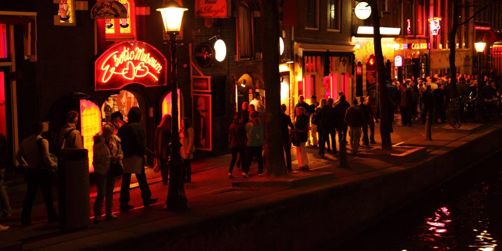 People strolling through Amsterdam's Red Light District at night 