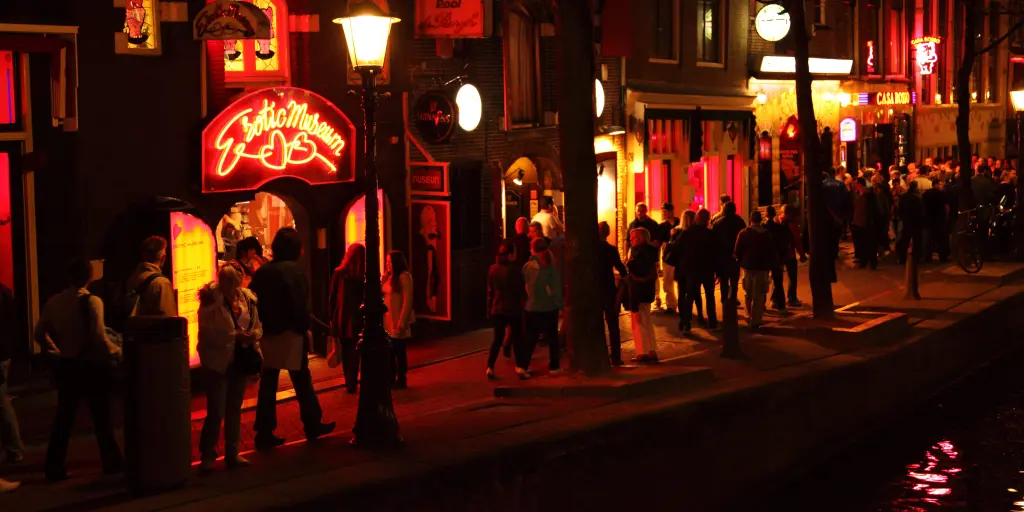People strolling through Amsterdam's Red Light District at night 