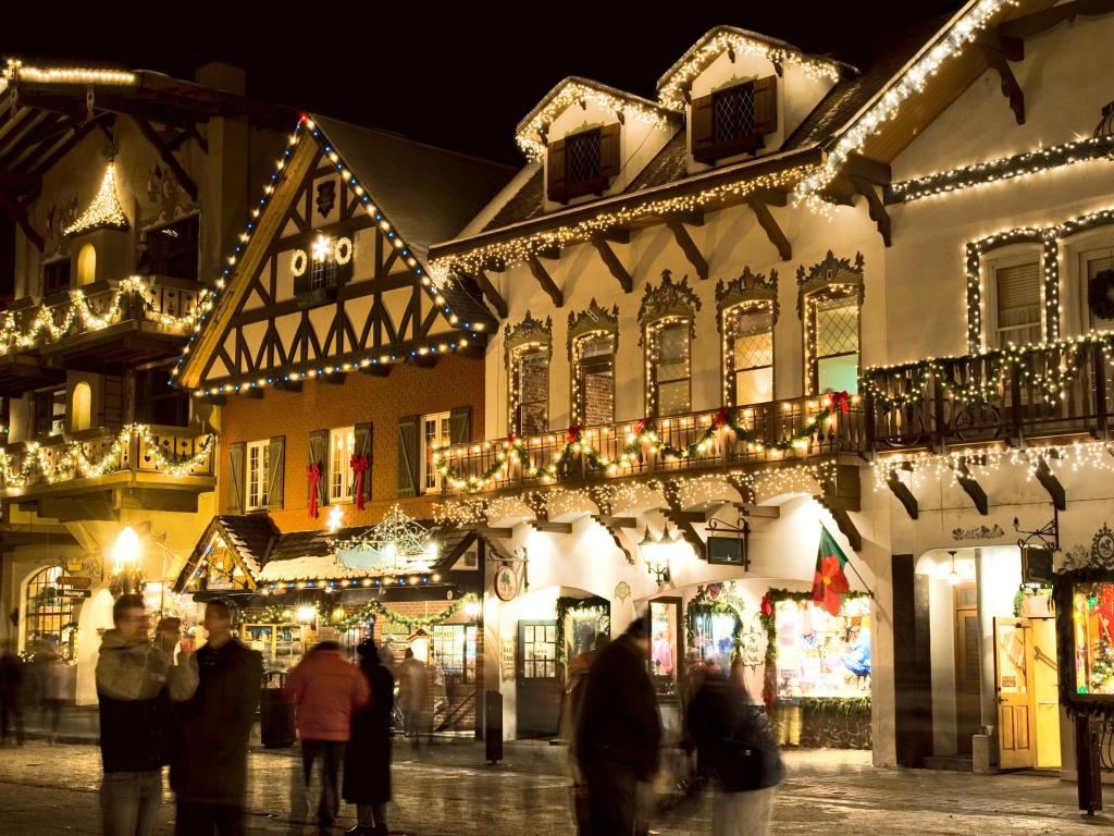 Festive decorations adorn shop fronts in Leavenworth, WA at Christmas at night time 