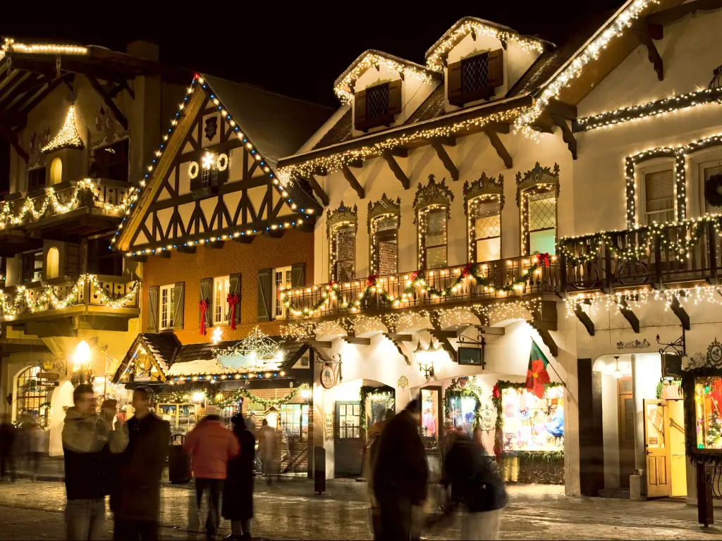 Festive decorations adorn shop fronts in Leavenworth, WA at Christmas at night time 