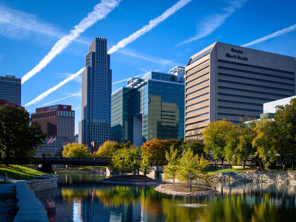 Omaha, Nebraska, USA with an evening view of the Omaha, Nebraska skyline from the Gene Leahy Mall.