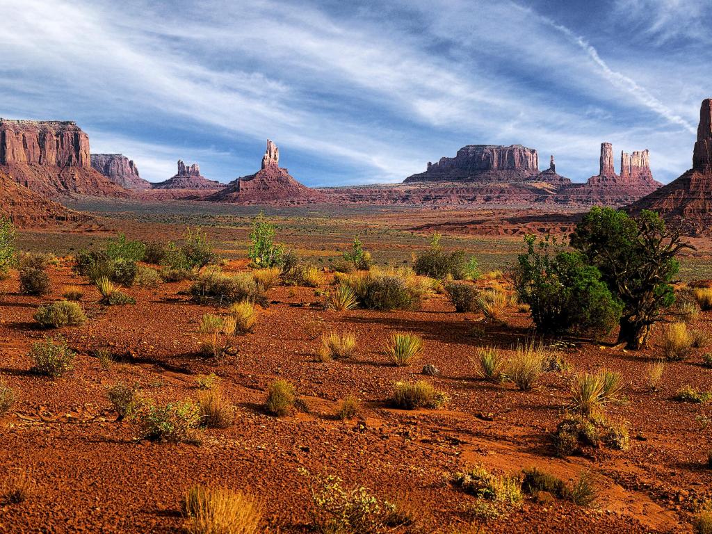 Strange rock formations emerging from dry red land