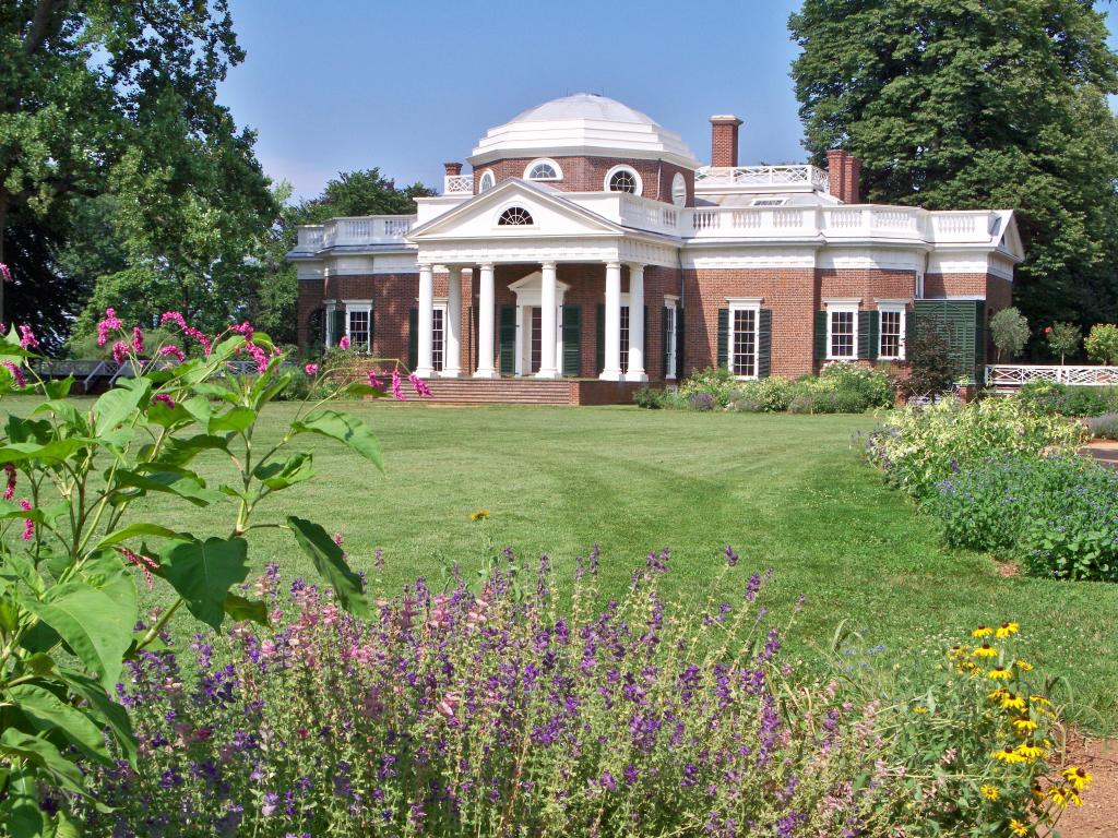 Thomas Jefferson's home Monticello on a clear spring day with flowers in the foreground.