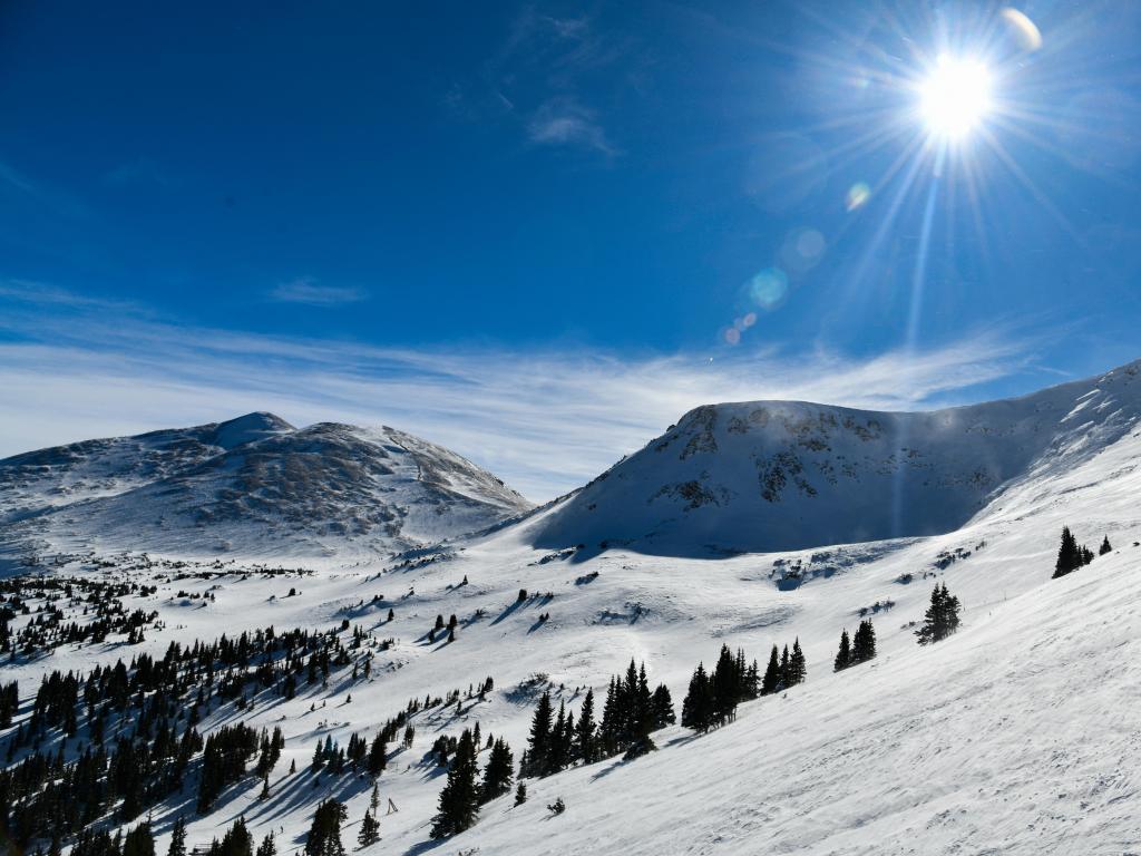 Breckenridge Colorado mountain view, with snow glistening in the bright sun and a blue sky above