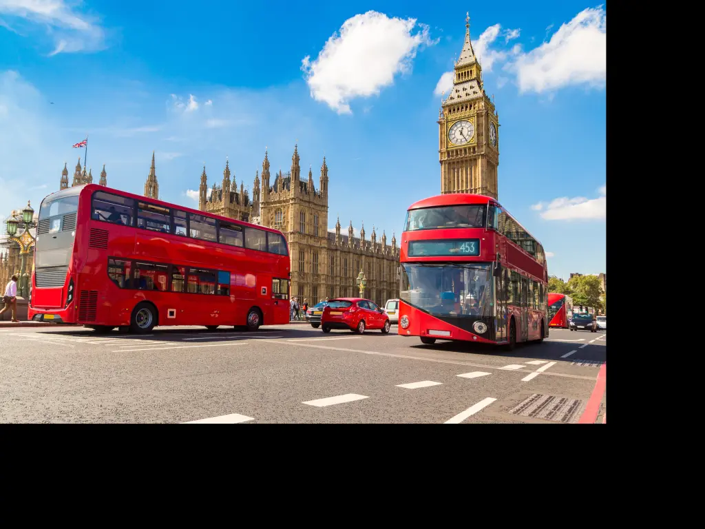 Red London Buses in front of the Houses of Parliament and Big Ben in London, UK