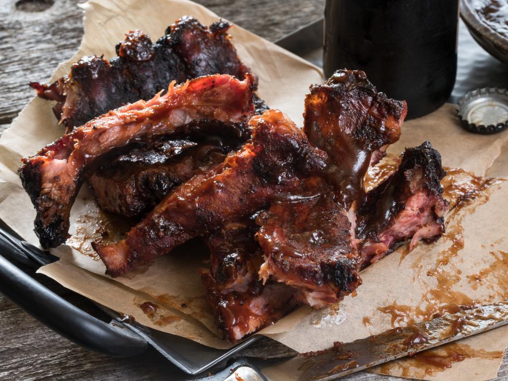 Kansas City style of barbecue includes thick and sweet BBQ sauce on ribs