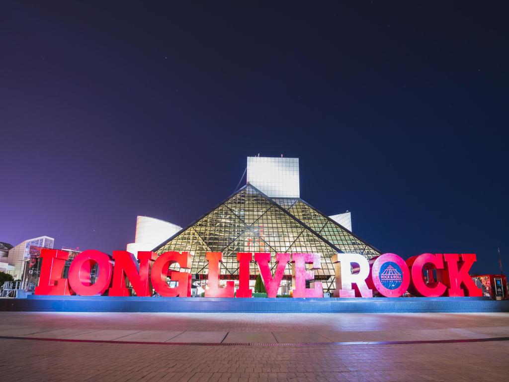 Shot of Cleveland's glass pyramid-shaped Rock and Roll Hall of Fame at night, with red letters spelling 