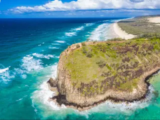 Fraser Island, Queensland, Australia with a view of the famous Indian Head part of the island surrounded by sea on a sunny day.