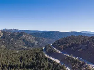 Aerial, panoramic View of I-80 cutting through the forest near Truckee California
