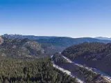 Aerial, panoramic View of I-80 cutting through the forest near Truckee California