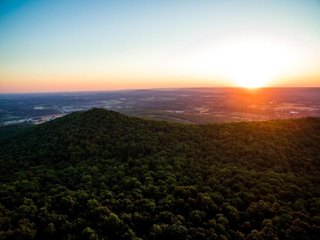 Huntsville, Alabama with a sunrise over Monte Sano Mountain in the foreground and overlooking the town in the distance.