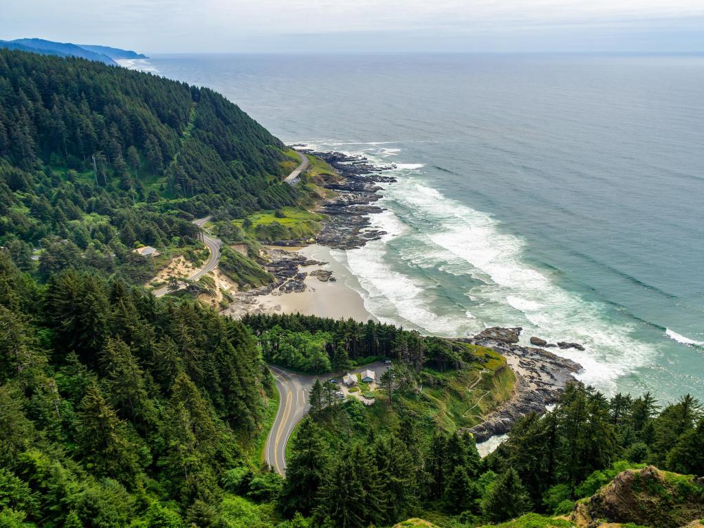 Aerial shot of US Highway 101 - the Pacific Coast Highway - winding its way past the scenic overlook at Cape Petpetua, with mist settling on the Ocean