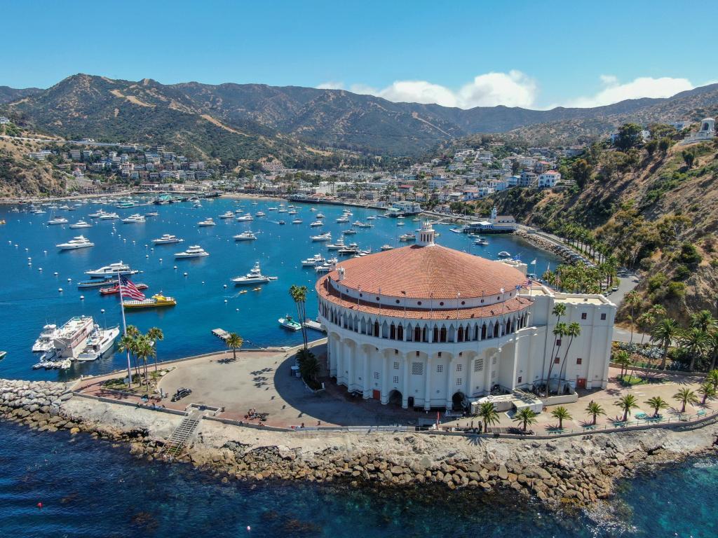 Bird's-eye view of Catalina Casino and Avalon Harbor, showcasing sailboats, fishing vessels, and yachts anchored