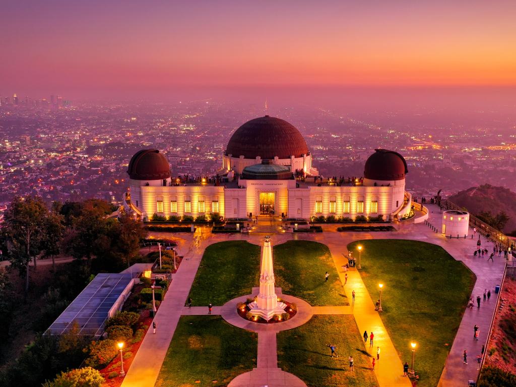 A very late pink sunset photo of Griffith Observatory with all the lights of the building turned on