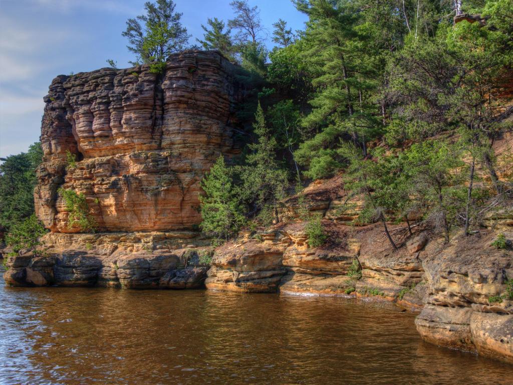 Witches Gulch, Wisconsin Dells, USA with fascinating rock formations and trees above, water in the foreground and taken on a sunny day.