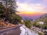 Road trip with snow in California's Yosemite National Park, California, with sunset on the horizon