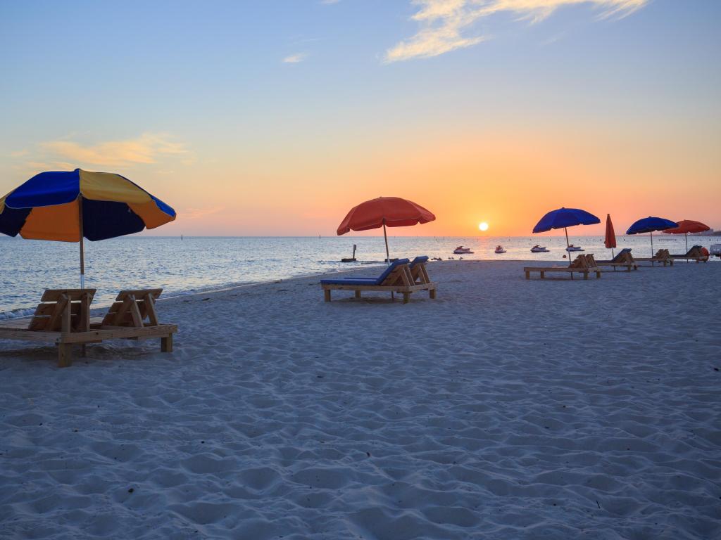Beautiful sunset in Biloxi beach, dotted with colourful beach umbrellas along the Gulf Coast shore, Mississippi