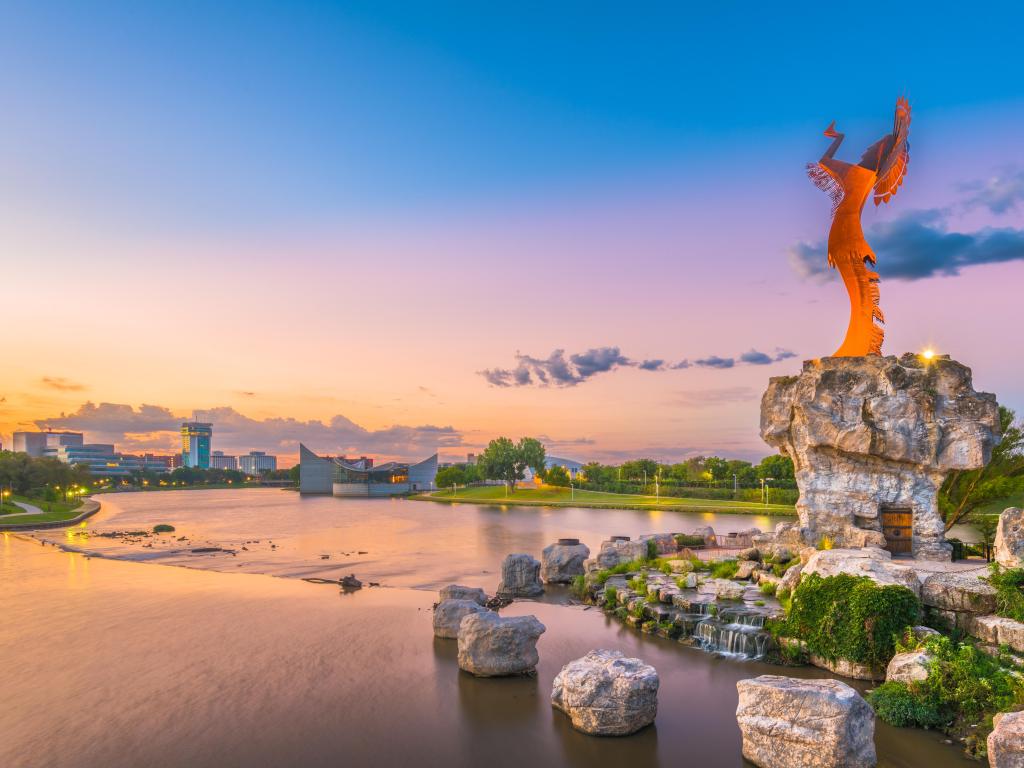 Wichita, Kansas, USA Downtown Wichita at dawn from the Arkansas River and Keeper of the Plains.