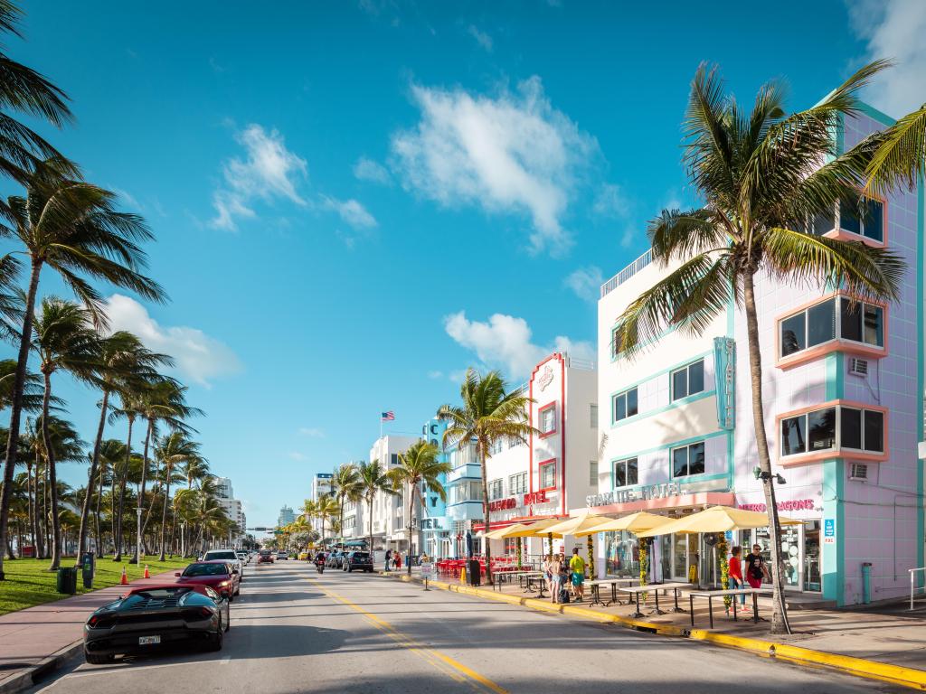 White and pastel colored houses, palm trees and cars