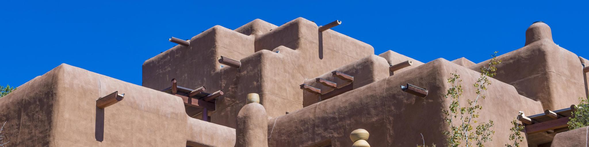 Traditional adobe house in Santa Fe on a sunny day with blue sky