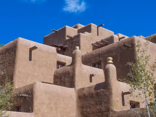 Traditional adobe house in Santa Fe on a sunny day with blue sky