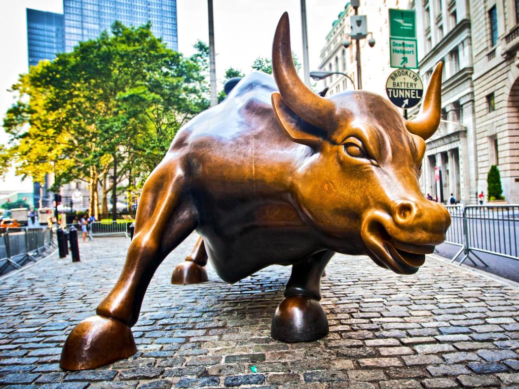 Close up of the landmark gold statue known as Charging Bull in Lower Manhattan