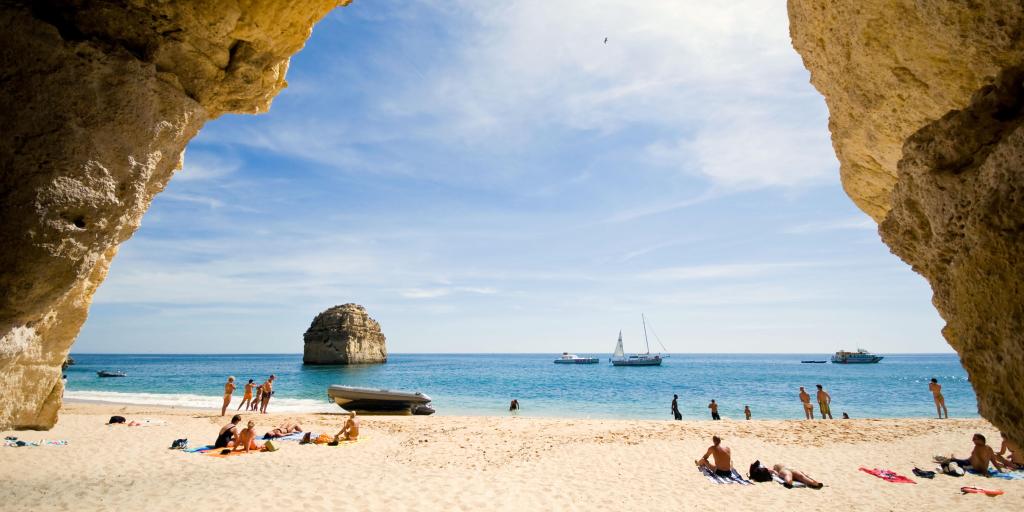 A few people sunbathing on a beach in Portugal 