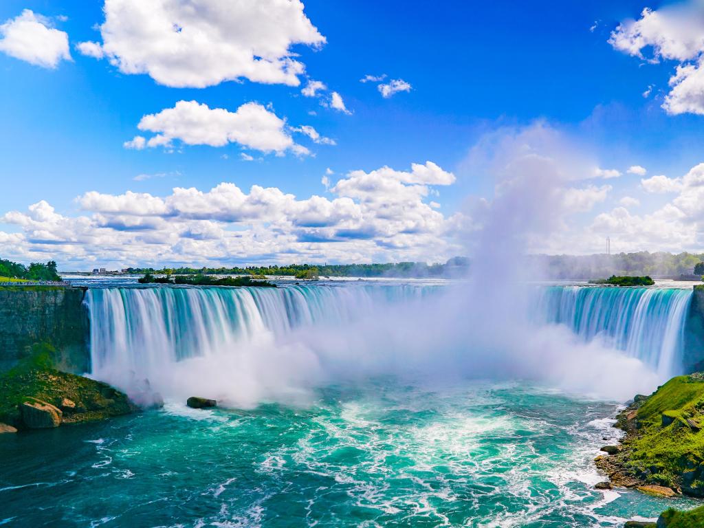 Niagara Falls, New York, USA taken on a sunny day with a clear view of the falls in the centre of the image. 