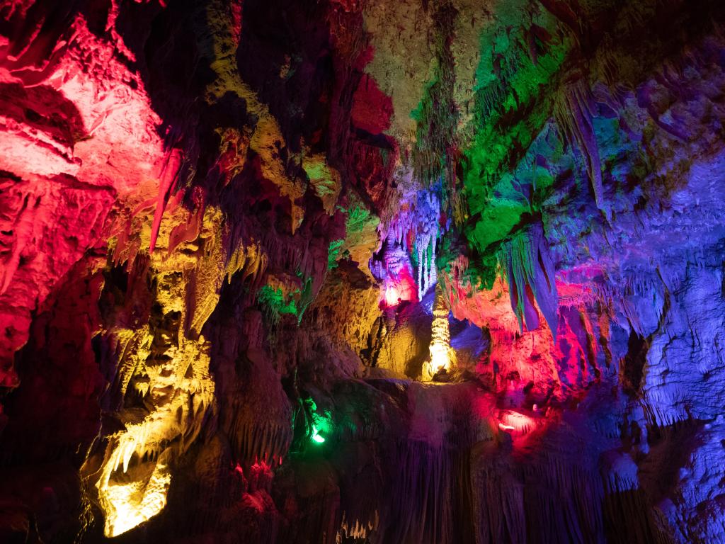 Meramec Caverns, lit up in red, blue, yellow and green lights.