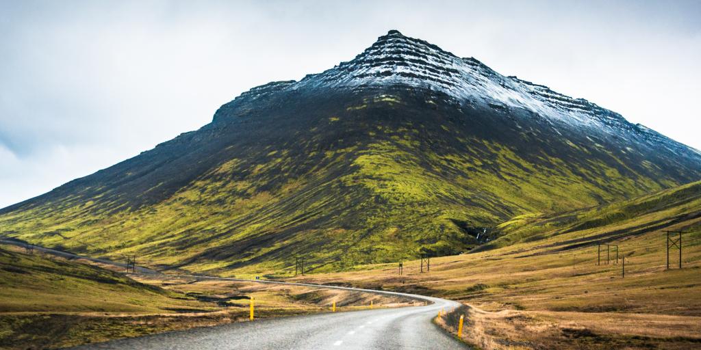 A road leads to a snow-capped mountain along Route 1 in Iceland