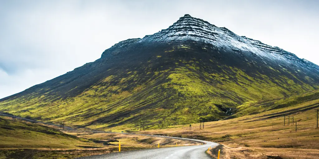 A road leads to a snow-capped mountain along Route 1 in Iceland