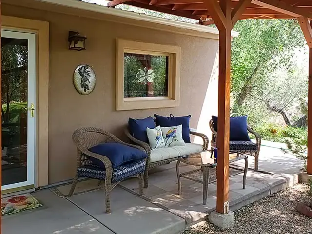 Outdoor terrace at seating in the shade, at Grizzly Roadhouse Bed and Breakfast