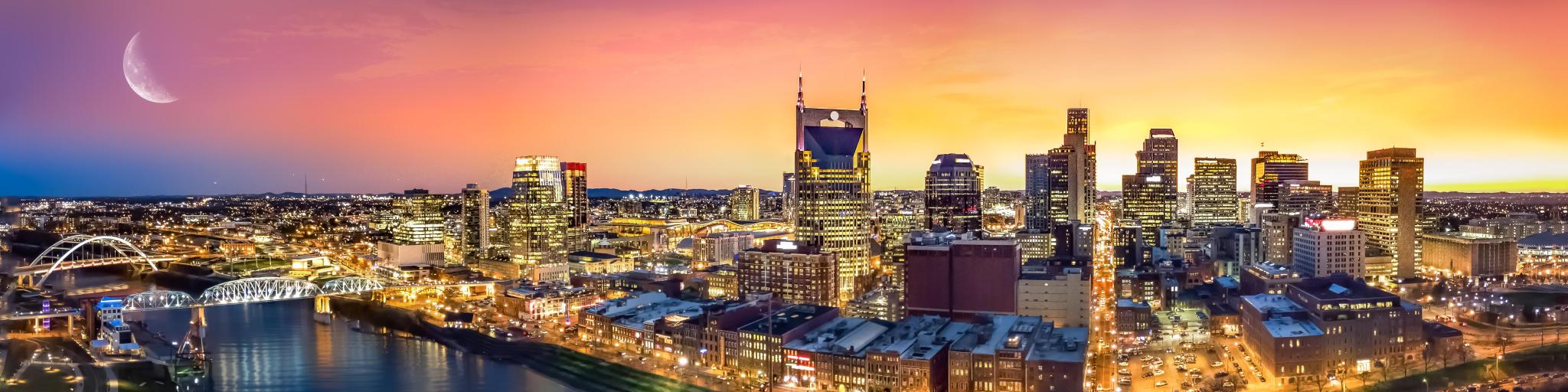 Nashville, Tennessee, USA skyline with moon at sunset.