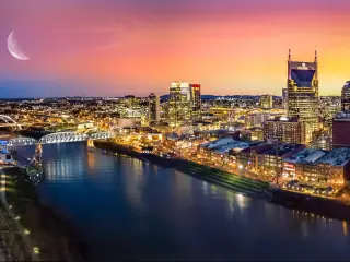Nashville, Tennessee, USA skyline with moon at sunset.