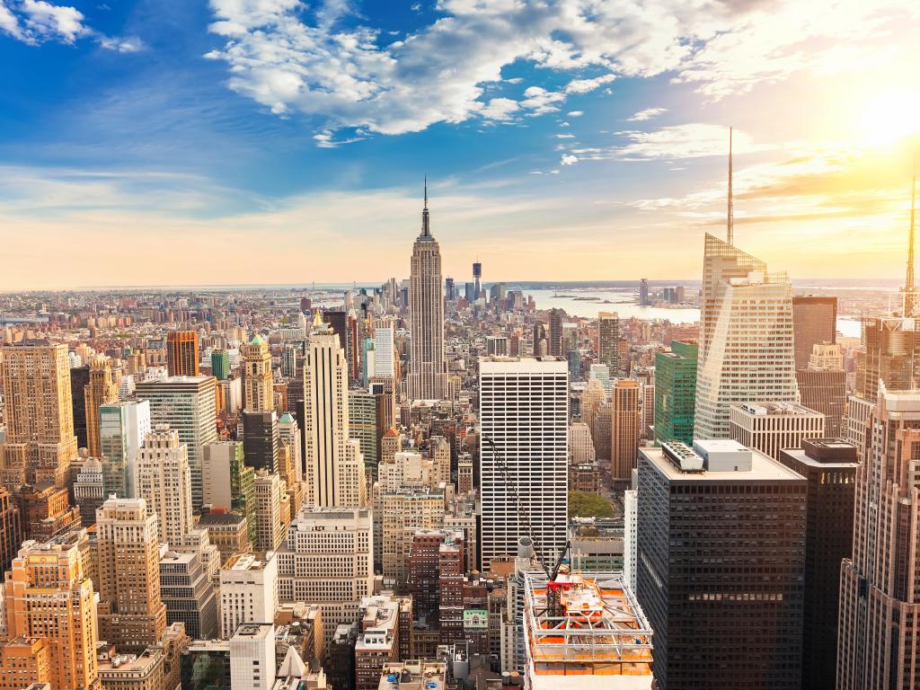 New York City skyline with the Empire State Building and Manhattan Midtown as the sun sets.