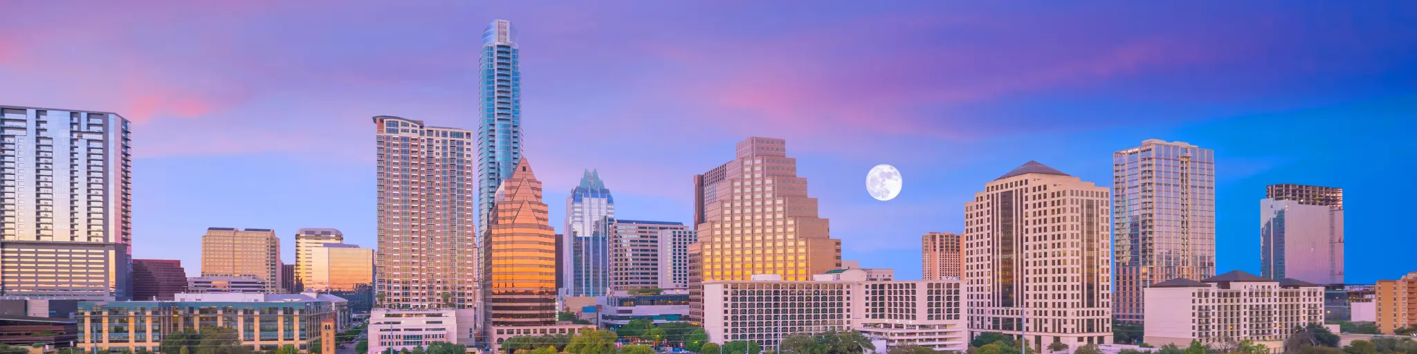 Downtown Austin skyline after sunset, purple sky with a full moon